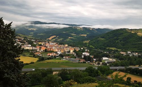 Town by mountain against sky