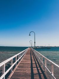 Beautiful wooden pier on an australian beach against clear sky