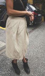 Low section of man standing on street