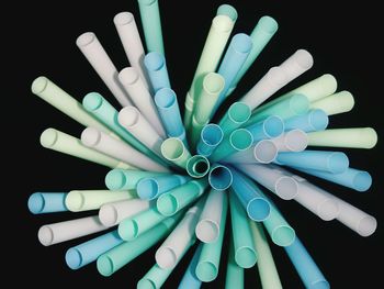 Close-up of straws against black background