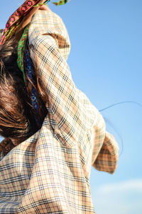 Rear view of woman against sky