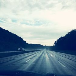 Road against sky seen through car windshield