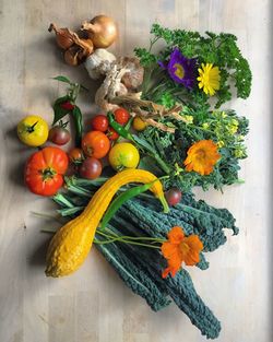 Directly above shot of vegetables and flowers on table
