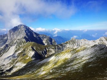 Low angle view of mountains against blue sky