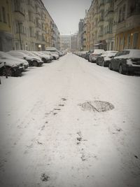 Snow covered city against sky