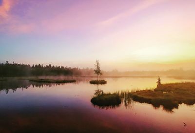 Scenic view of lake against sky during sunset