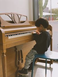 Full length of boy sitting on seat