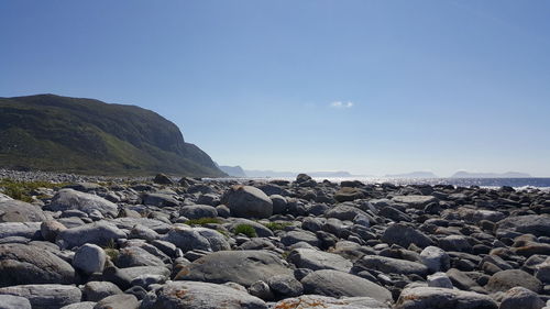 Rocks by sea against sky