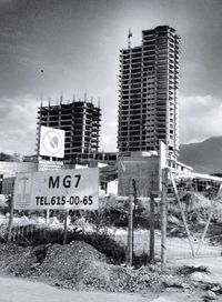 Information sign against sky