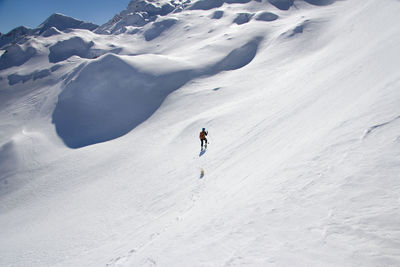 Person skiing on snowcapped mountain