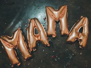 High angle view of mama text helium balloons on floor