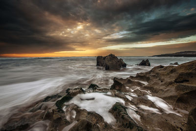 Scenic view of sea against cloudy sky