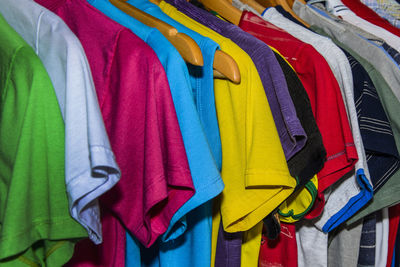 Full frame shot of multi colored clothes hanging on rack at store