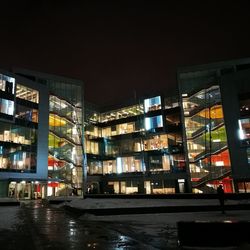 Illuminated city against sky at night