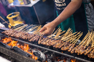 Man preparing food on barbecue grill