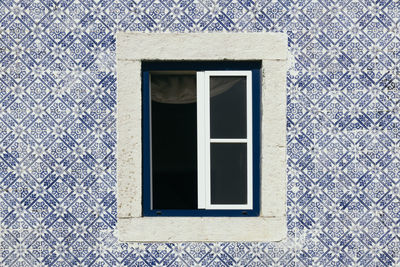 Window in a wall with azulejos.