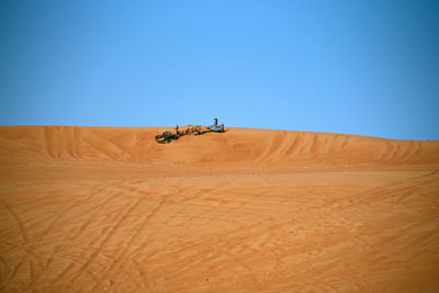 Scenic view of desert against clear blue sky