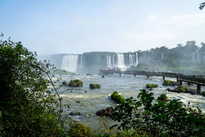 Scenic view of waterfall against sky