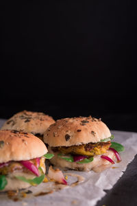 Close-up of burger against black background