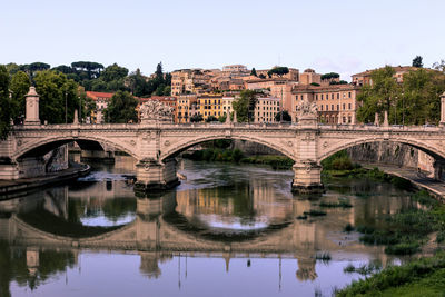 Arch bridge over river against clear sky