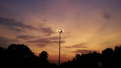 Low angle view of silhouette trees against sky at sunset