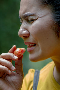 Close-up of young woman eating food
