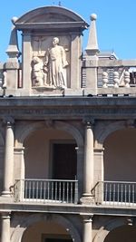 Low angle view of statue against building