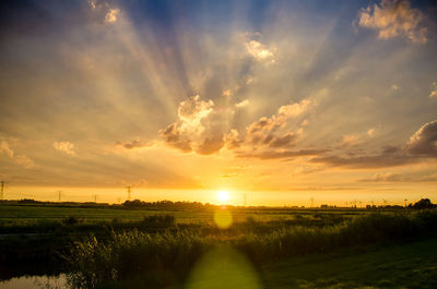 Scenic view of field against sky during sunset