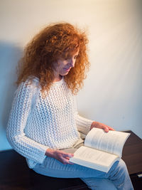 Midsection of woman reading book