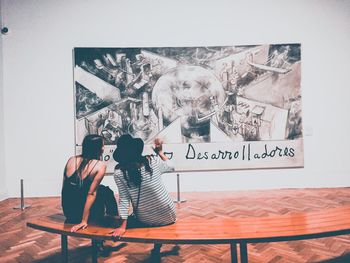 Panoramic shot of people standing against wall