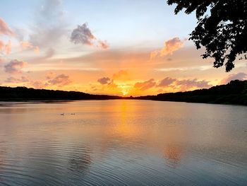 Scenic view of lake against orange sky