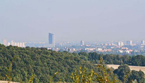 Panoramic view of trees and buildings against clear sky
