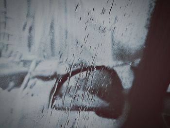 Close-up of hand on window