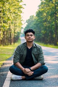 Portrait of young man sitting outdoors