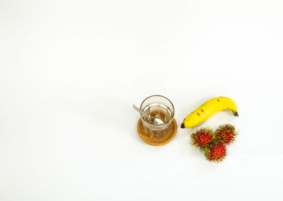 High angle view of fruits against white background