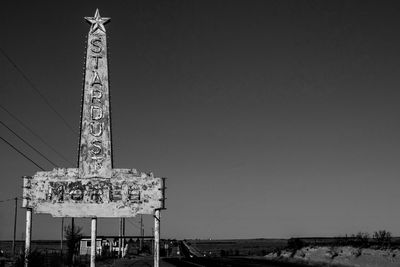 Low angle view of communications tower against sky