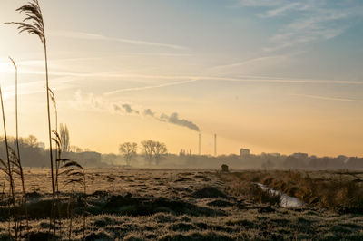 Silhouette of smoke from smoke stack against sky