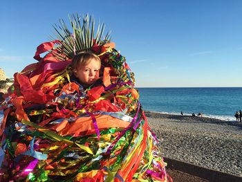 Portrait of baby wearing confetti against beach