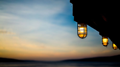 Low angle view of illuminated building against sky during sunset