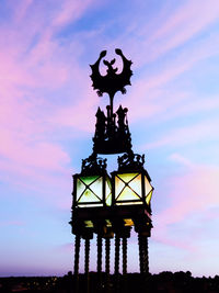 Low angle view of silhouette statue against sky during sunset