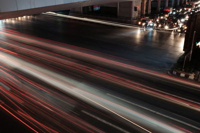 Light trails on road in city at night