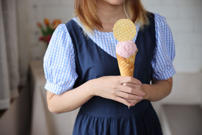 Midsection of woman holding heart shape