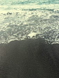 High angle view of waves on beach