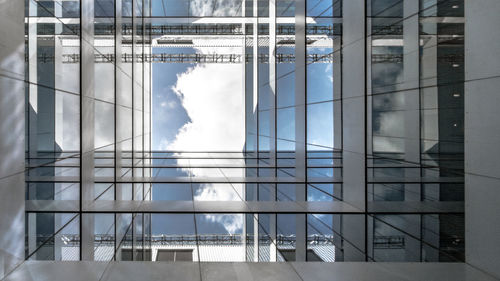 Digital composite image of modern building against sky