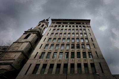 Low angle view of building against cloudy sky