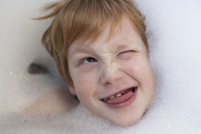 Close-up boy in soap sud