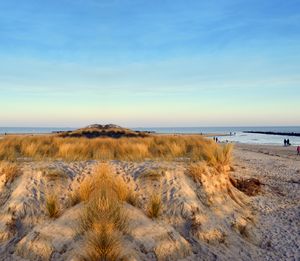 Scenic view of beach against sky during sunset