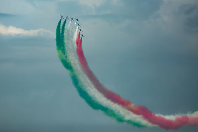 Low angle view of airshow in mid-air against sky