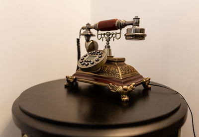 Close-up of old telephone on table