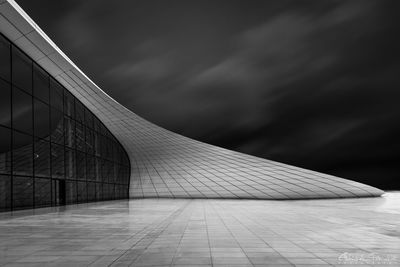 View of modern building against cloudy sky